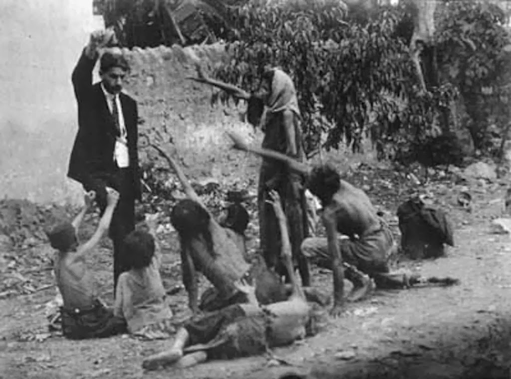 Turkish official teases starving Armenian children by showing them a piece of bread during the Armenian Genocide in 1915.