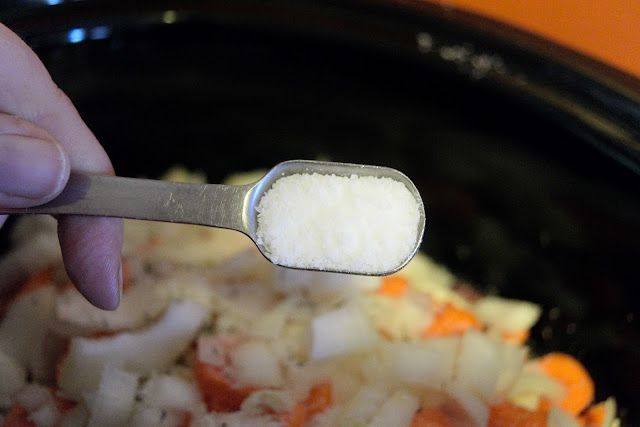 Salt being added to the crock pot.