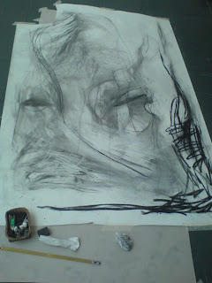 Large black and white abstract drawing laid out on the floor.