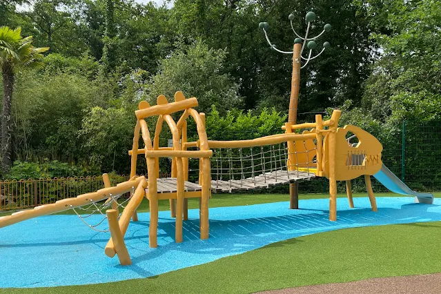 A wooden climbing frame that looks like a dinosaurs skeleton