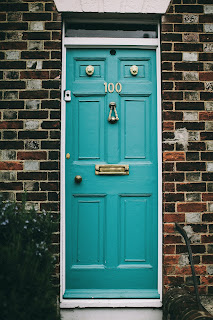 Photo of blue door with the # 100