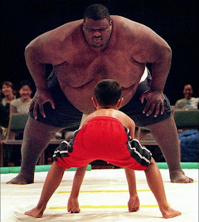 Crazy picture of a boy against Sumo