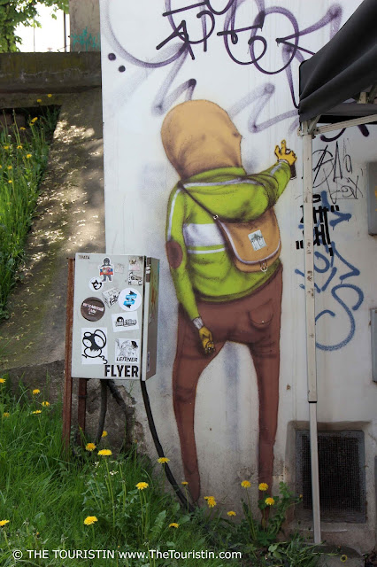 Mural of a guy with a spray can by artist Os Gemeos in Vilnius in Lithuania