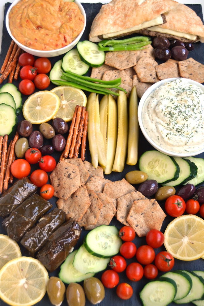 Greek Appetizer Platter is super easy to make with homemade Lemon, Feta and Dill Dip, Greek olives, tomatoes, grape leaves, hummus, pickles, peppers, gyro sandwiches and more. All ready in 10 minutes! www.nutritionistreviews.com