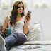 Woman Holding Cup Wearing Tank Top Sitting on Bed