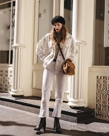25 of the Best White Denim Pieces for Fall and Winter — @nycbambi Christie Tyler in a black beret, white denim jacket, camel shearling bag, white raw-hem jeans, and black boots
