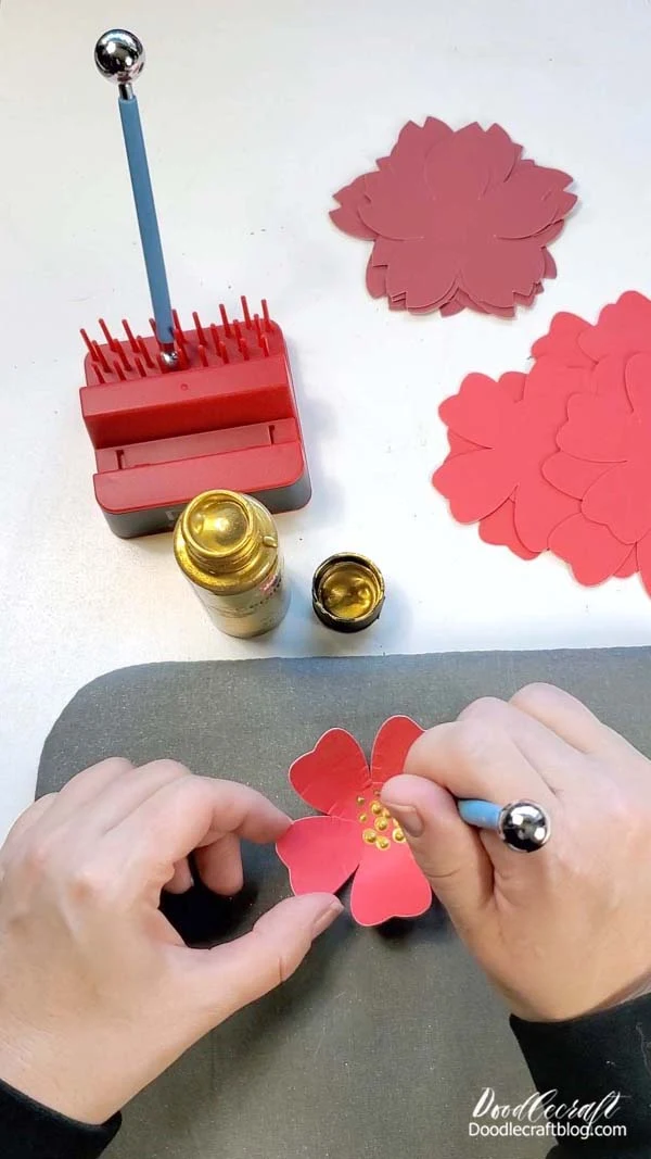 Step 4: Paint the Paper Flowers:   Using gold metallic acrylic paint and a dot tool, add decorative dots to the centers of each flower.    Allow the paint to dry completely before handling.