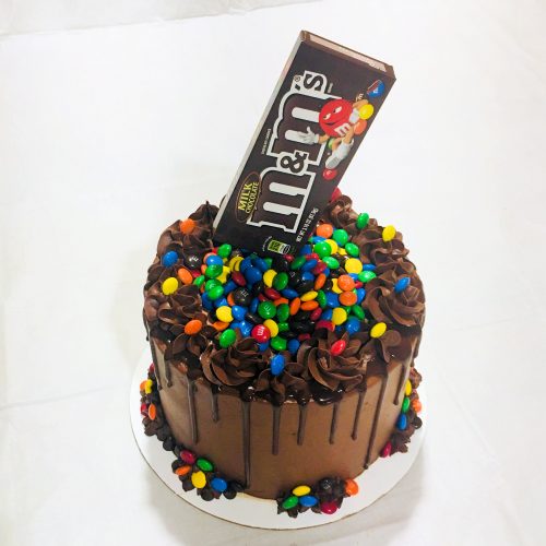 Candy-filled M&Ms Cake - Easy M&Ms cake chocolate cake filled with M&Ms candy and topped with a M&Ms box for a cool anti-gravity effect!