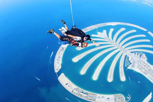 Singer, Banky W 'Dabs' in the Sky as He Jumps Off a Helicopter During Skydiving in Dubai (Photos)