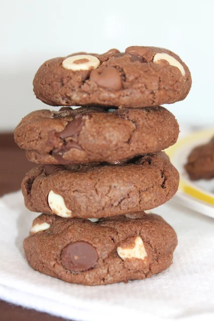 Stack of four triple chocolate chip chocolate cookies.