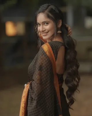 Tejaswini Gowda wearing a traditional saree, looking graceful and elegant in a sophisticated pose