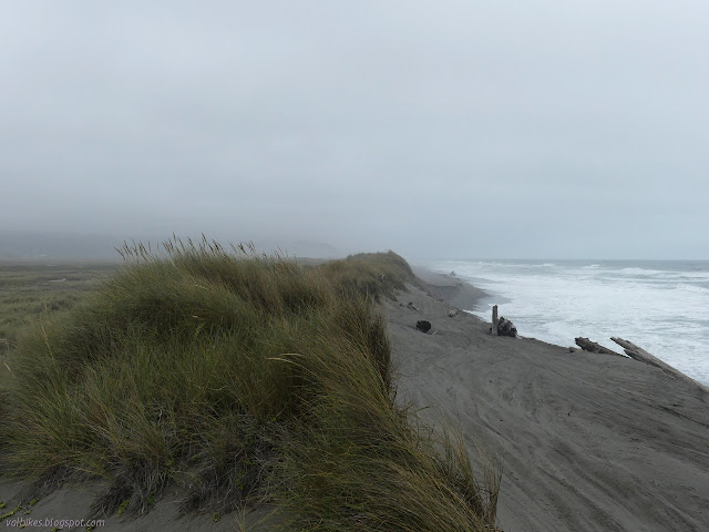 narrow beach and tall sand hill