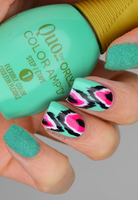 neon green ikat print nails holding nail polish bottle