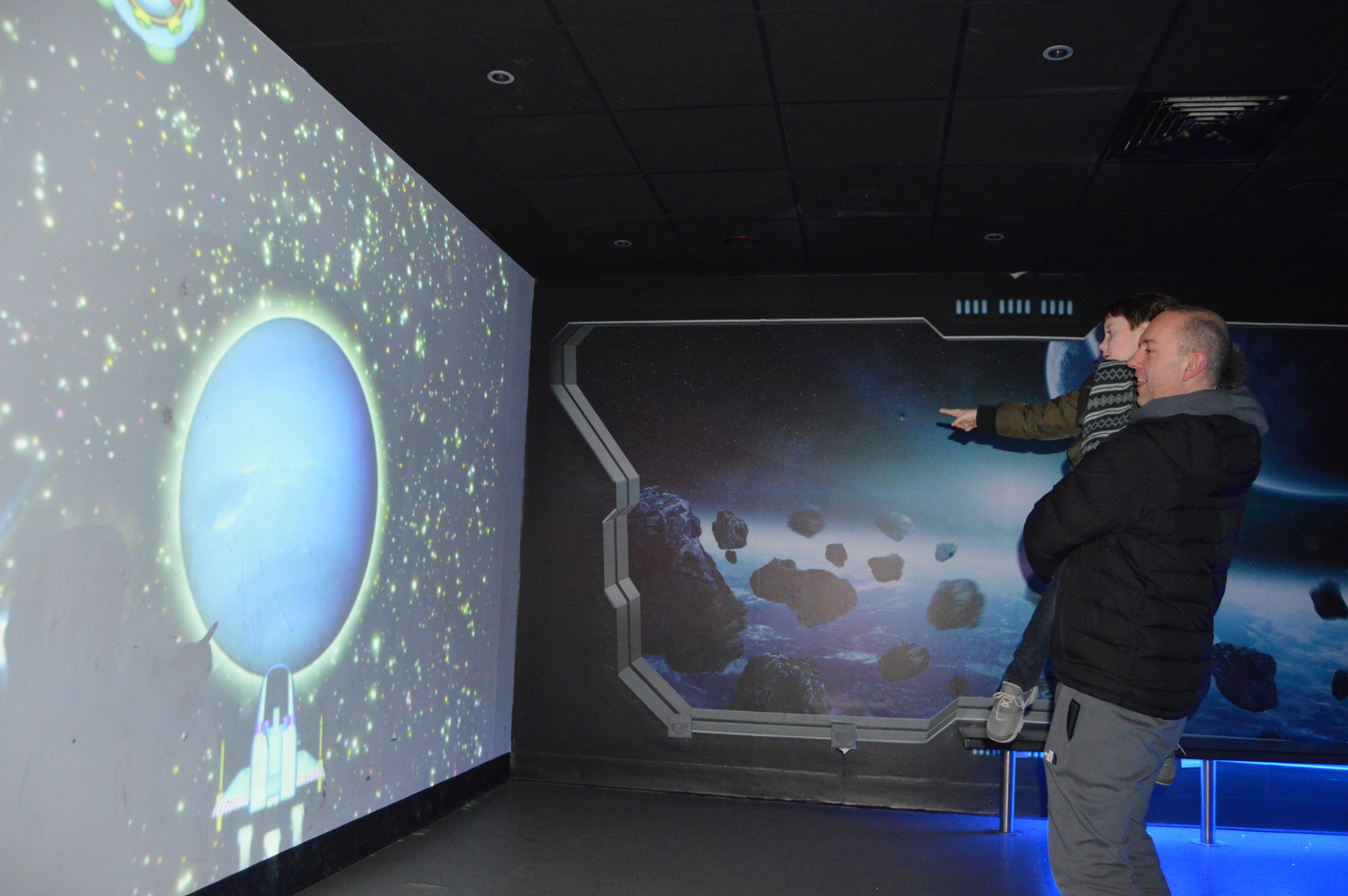 Dad and Son looking at an interactive planet activity