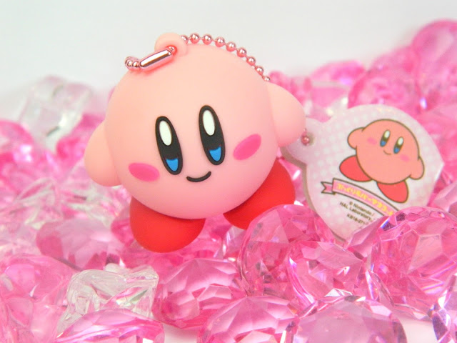 A Nintendo Kirby figural keychain and plastic pink gems 