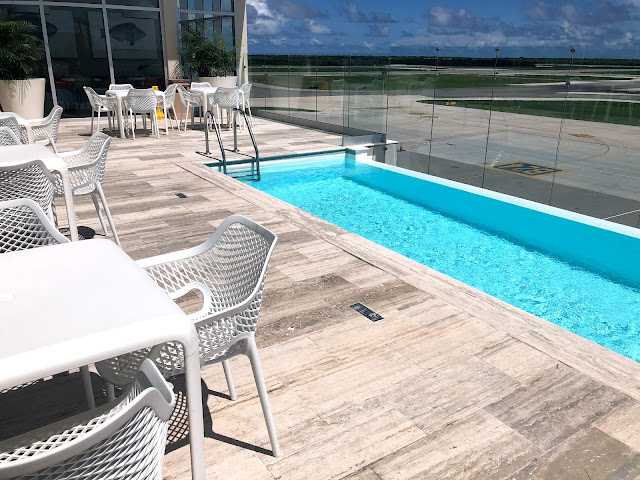 A sunny pool overlooking a runway.