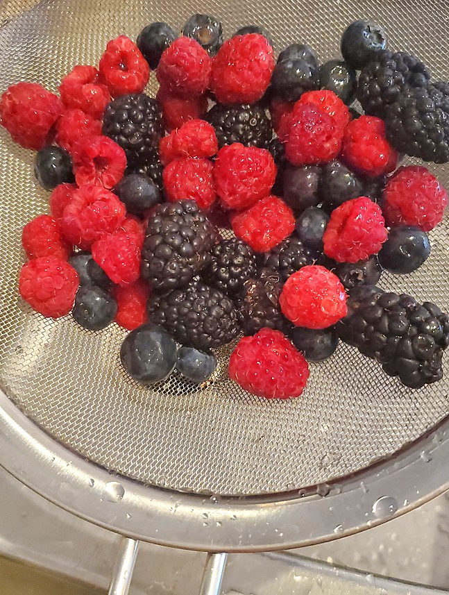 3 kinds of berries washed in a colander