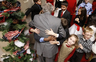 President George W. Bush is smothered in little hands