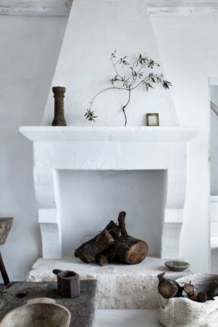 White plaster and stone fireplace in Italian farmhouse - found on Hello Lovely Studio