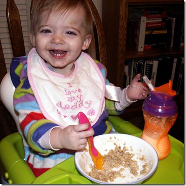 Eating feeding herself oatmeal with spoon