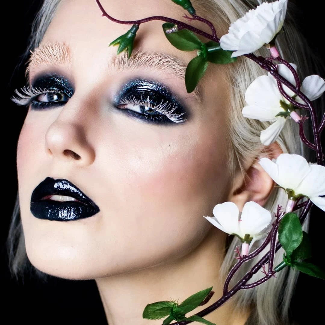 a portrait of a young woman with black glossy eyelind look and white lashes