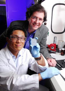 Caption: Georgia Tech researchers Joe Perry and Philseok Kim display a capacitor array device made with a barium titanate nanocomposite. Credit: Georgia Tech Photo: Gary Meek, Usage Restrictions: None.