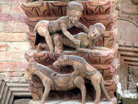 Wood carved scene decorating temple in Nepal