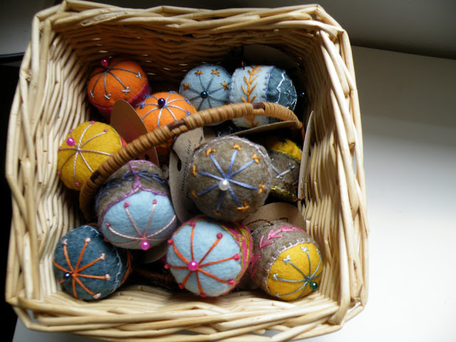 hand embroidered felt pincushions made from wine screw caps, wadding and felt 