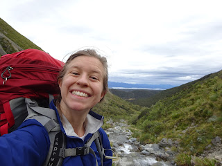 author posing for selfie on mountain ridge