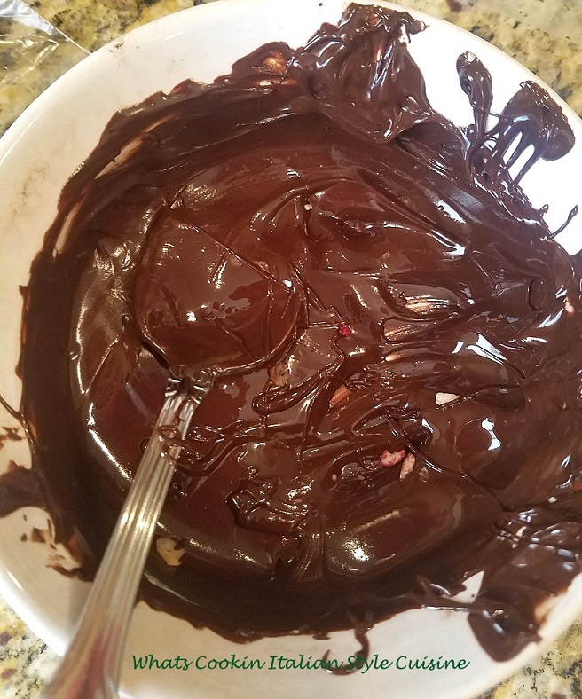 this is melted chocolate in a white bowl for dipping cookies into