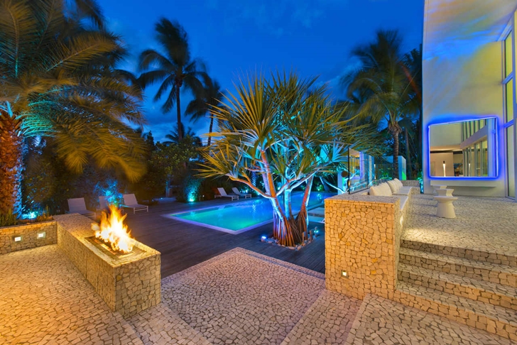 Backyard of Modern mansion in Miami at night 