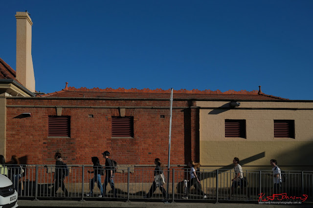 Redfern Station ,Uni Students, and terracotta ridge capping against a blue Australian sky. - Fujifilm X100VI in Newtown