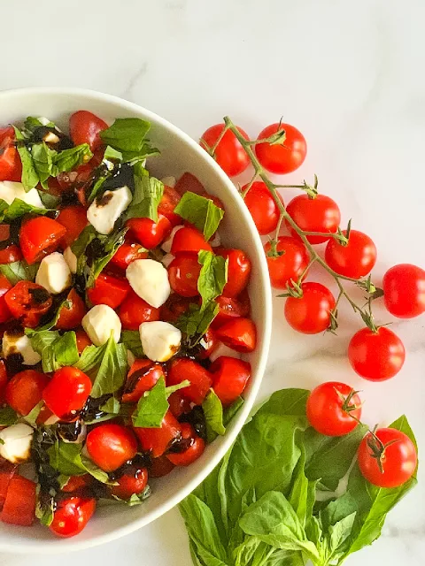My Easy Chopped Cherry Caprese Salad is loaded with ripe cherry tomatoes, fresh basil, and fresh mozzarella pearls and drizzled with a balsamic glaze.