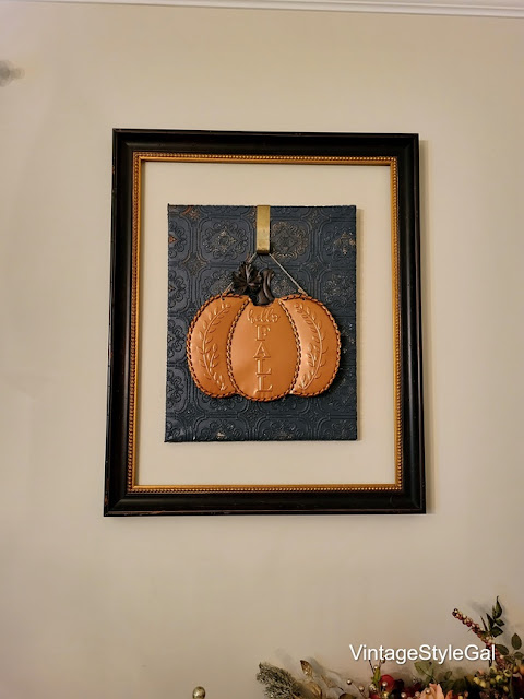 Fall decor hanging on wall with pumpkin