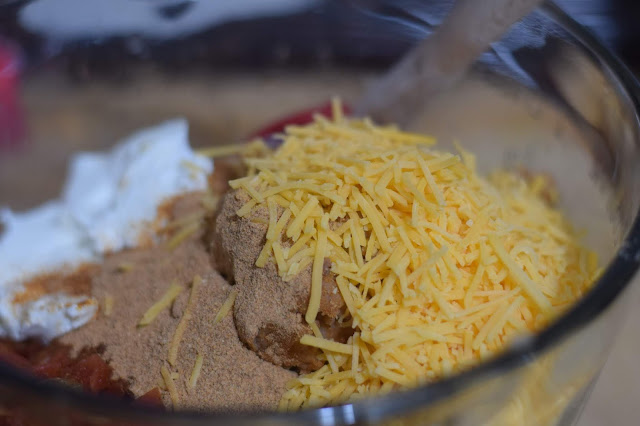 shredded cheese being added to the bowl.