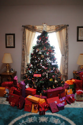 big christmas tree with beautiful gifts underneath