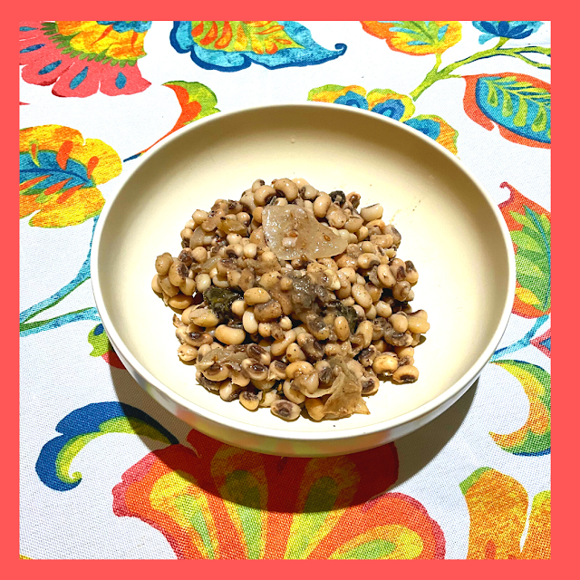 bowl of cooked black-eyed peas on paisley table cloth