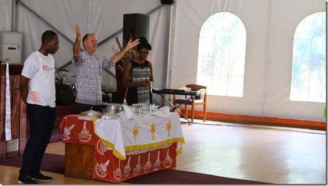 Steve at the communion table with Ebola Safe Elements