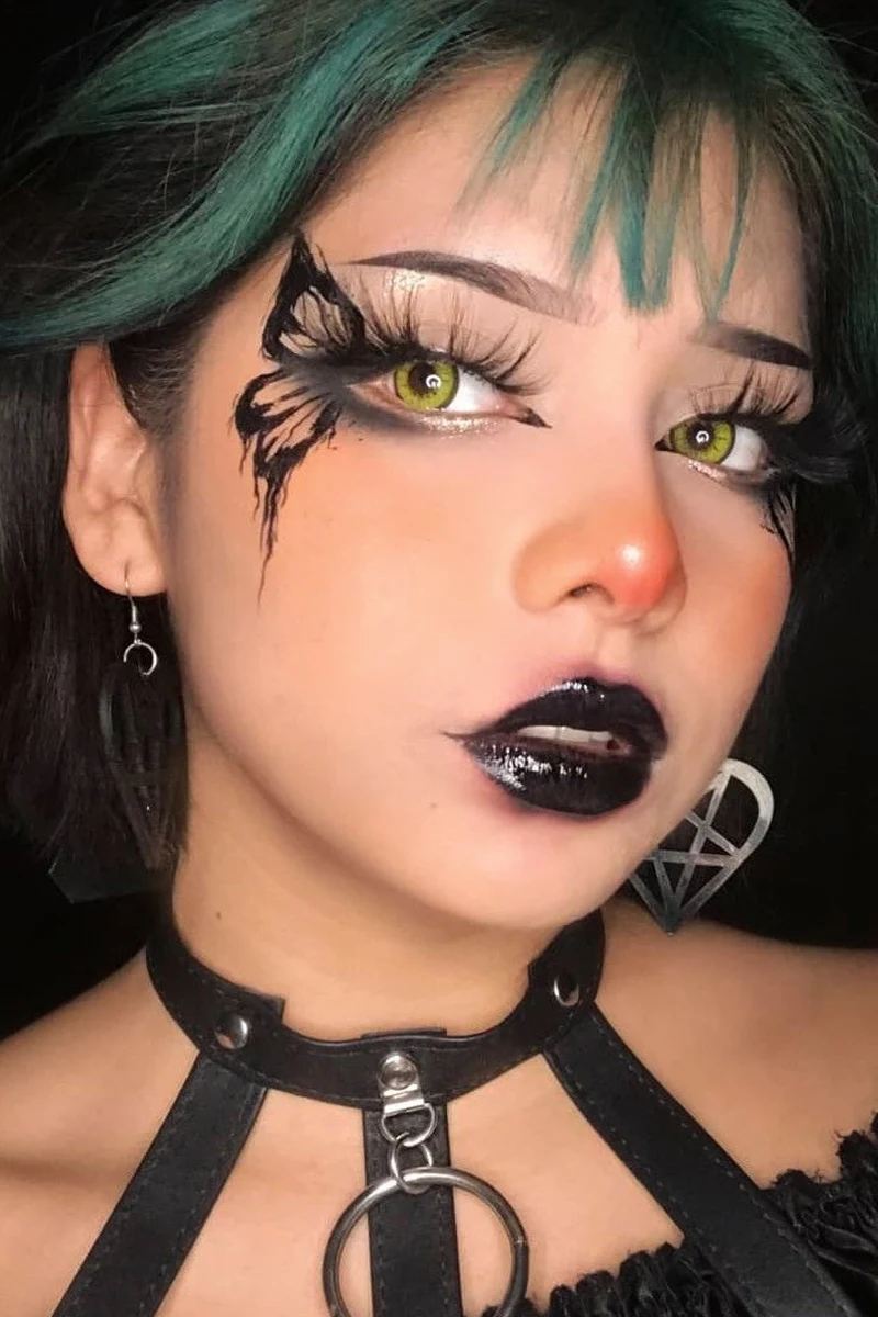 close-up portrait of a young, beautiful woman with goth eyeliner makeup look