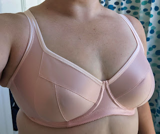 Photo of a pink duoplex bra with fold over elastic at the upper cup edge and underarm.