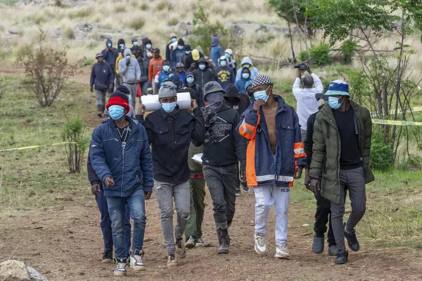 Volunteer rescue workers and community members leave a mine shaft where illegal miners are trapped in a disused mine in Stilfontein, South Africa, Thursday, Nov. 14, 2024. Jerome Delay/Copyright 2024 The AP. All rights reserved.