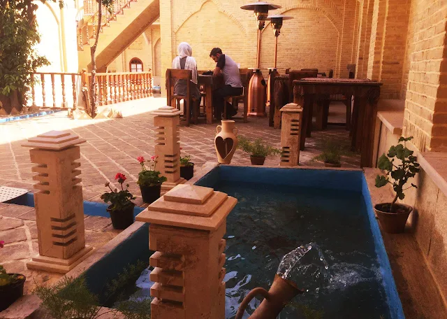 The guests sitting in the courtyard of Forough Boutique Hotel.