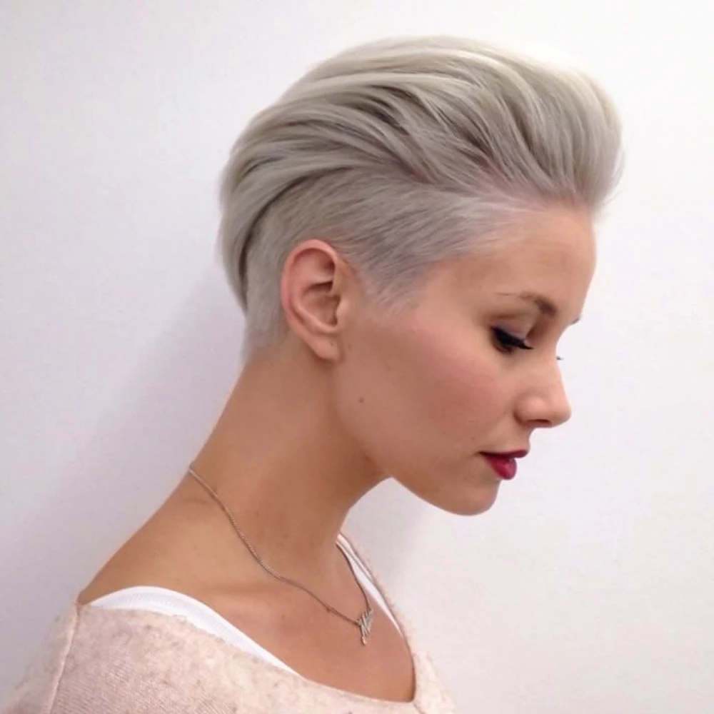 a portrait of a young woman with platinum blonde hair and undercut