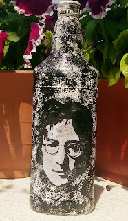 This recyled bottle has image of John Lenon decoupaged on it and the textured created with gesso and acrylic color. 