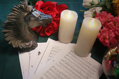 photo of horse statue, sheet music, flowers and candles taken by chorale member E. Schneider