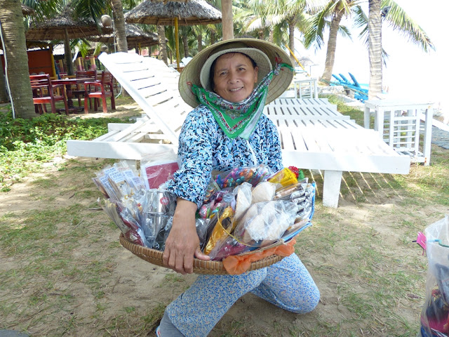 Vietnamese woman selling souvenirs at Cua Dai beach Hoi An