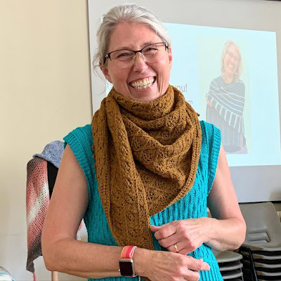 Emma wearing hand knitted shawl wrapped around neck