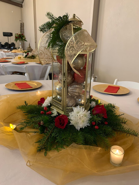 Gold lantern with Christmas ornaments and flowers