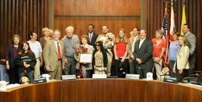 Pat Whitehead and her puppy club members in the City Council chambers