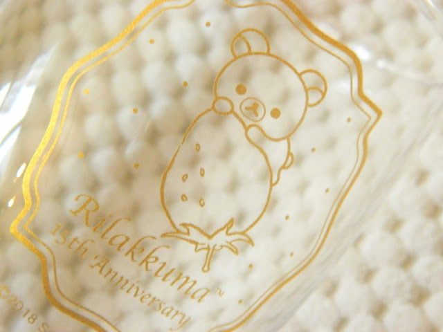 A glass with a picture of Korilakkuma on it in gold 